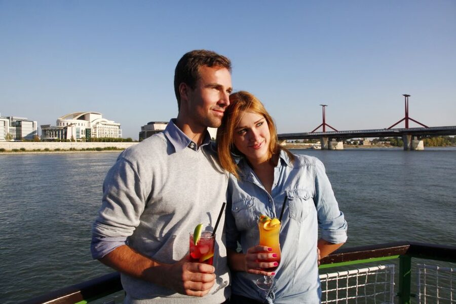 Budapest: 1 hr Sunshine Booze Cruise with Prosecco - The National Theatre and the changing riverfront